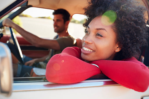 a beautiful woman leaning out of the car passenger window