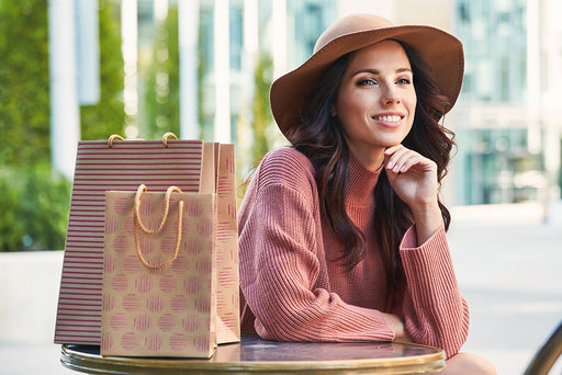 a smiling beautiful woman with her shopping bags