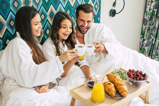 a family eating breakfast in their bedroom