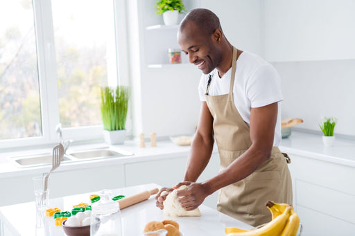 Man kneading pastry on a clean work surface