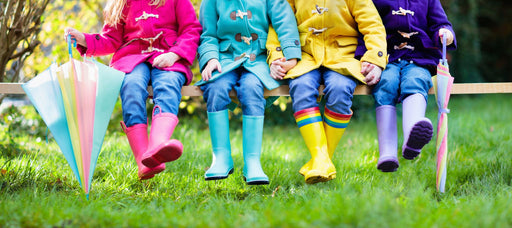 children in brightly colored winter coats and galoshes