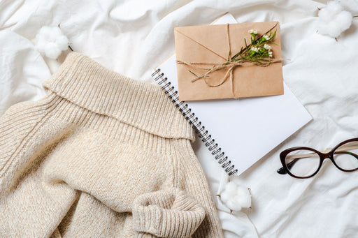 cashmere roll neck placed decoratively on a white sheet