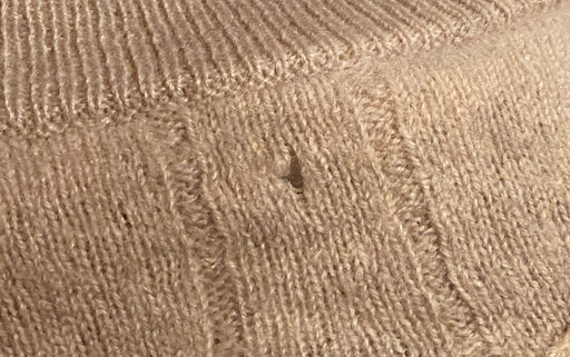 another cashmere wool with holes caused by moth larvae