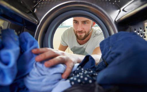 man loading the washing machine