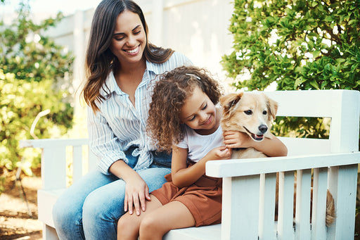 a mother and child with their family dog