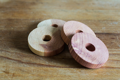 cedar blocks with holes in the center for placing on hangers