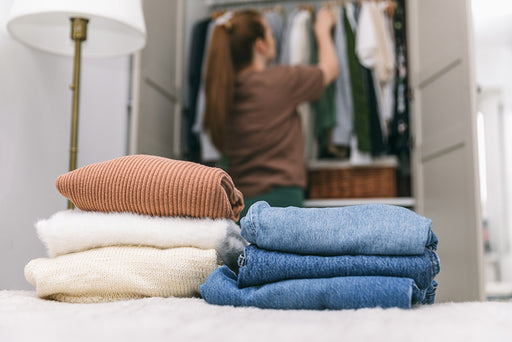 a woman cleaning and  tidying her closet