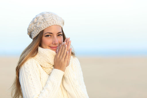 a woman looking warm and snug in fresh cream knits