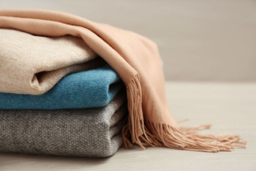 a luxurious pile of cashmere garments