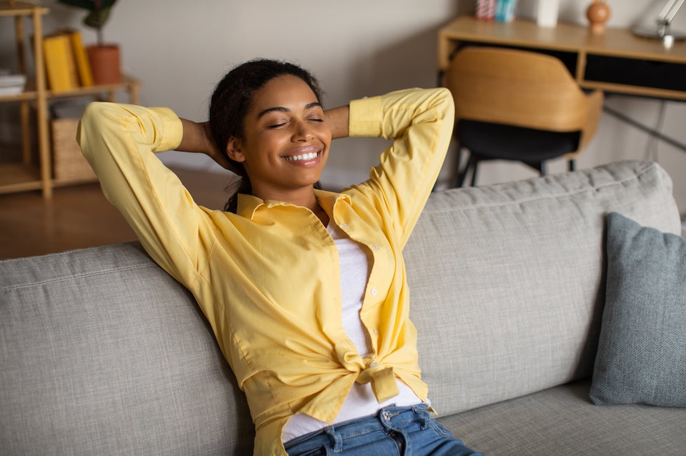 a woman relaxing on her couch in a clean home
