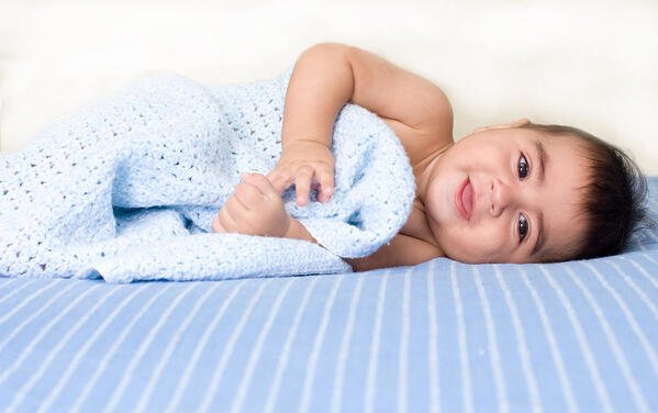 a baby wrapped in a soft wool blanket