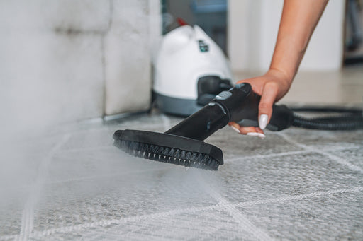 a close of a carpet being steam cleaned