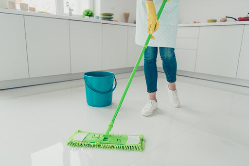 a close up of a kitchen floor being mopped