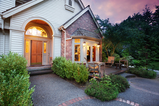 a welcoming home with the lights on at dusk