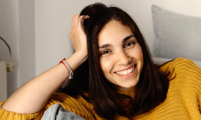 smiling woman sat on sofa