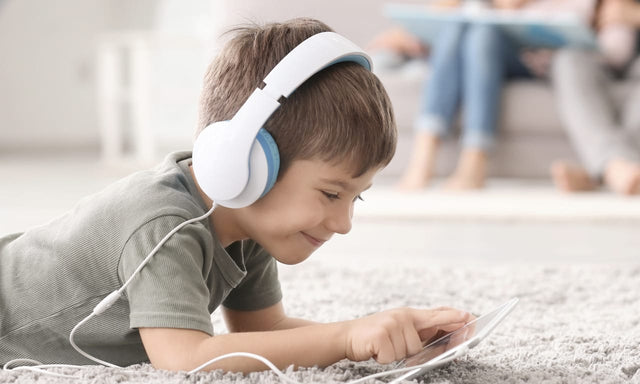 child on carpet using tablet