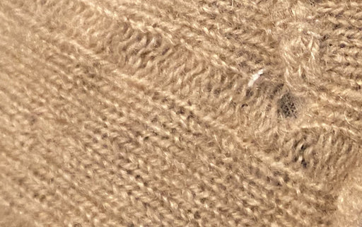 cashmere wool with holes caused by moth larvae
