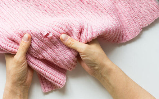 example of pink woollen sweater with moth damage