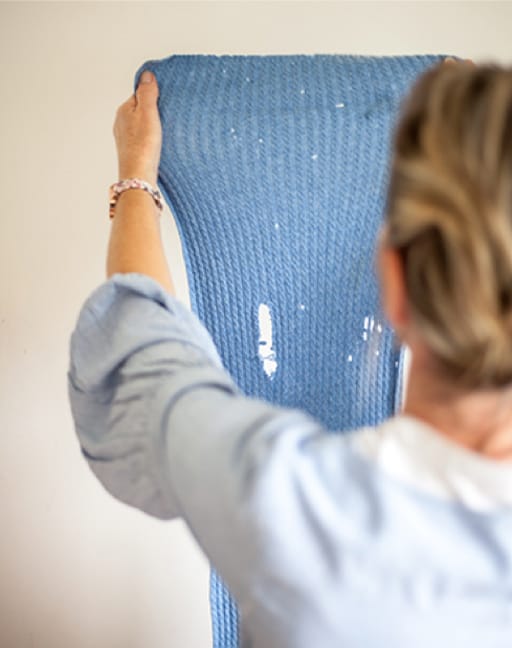 woman holding moth damaged wool