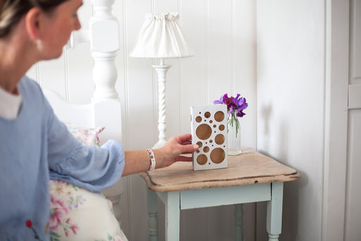 placing a MothPrevention Moth Trap by the bedside table