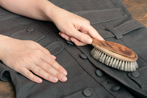 gray coat being brushed