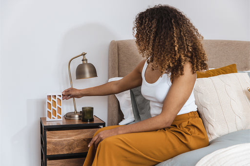placing a MothPrevention Moth Trap by the bedside table